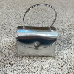 Silver purse rhinestones on clasp. Six inches by four. Handle is 10”